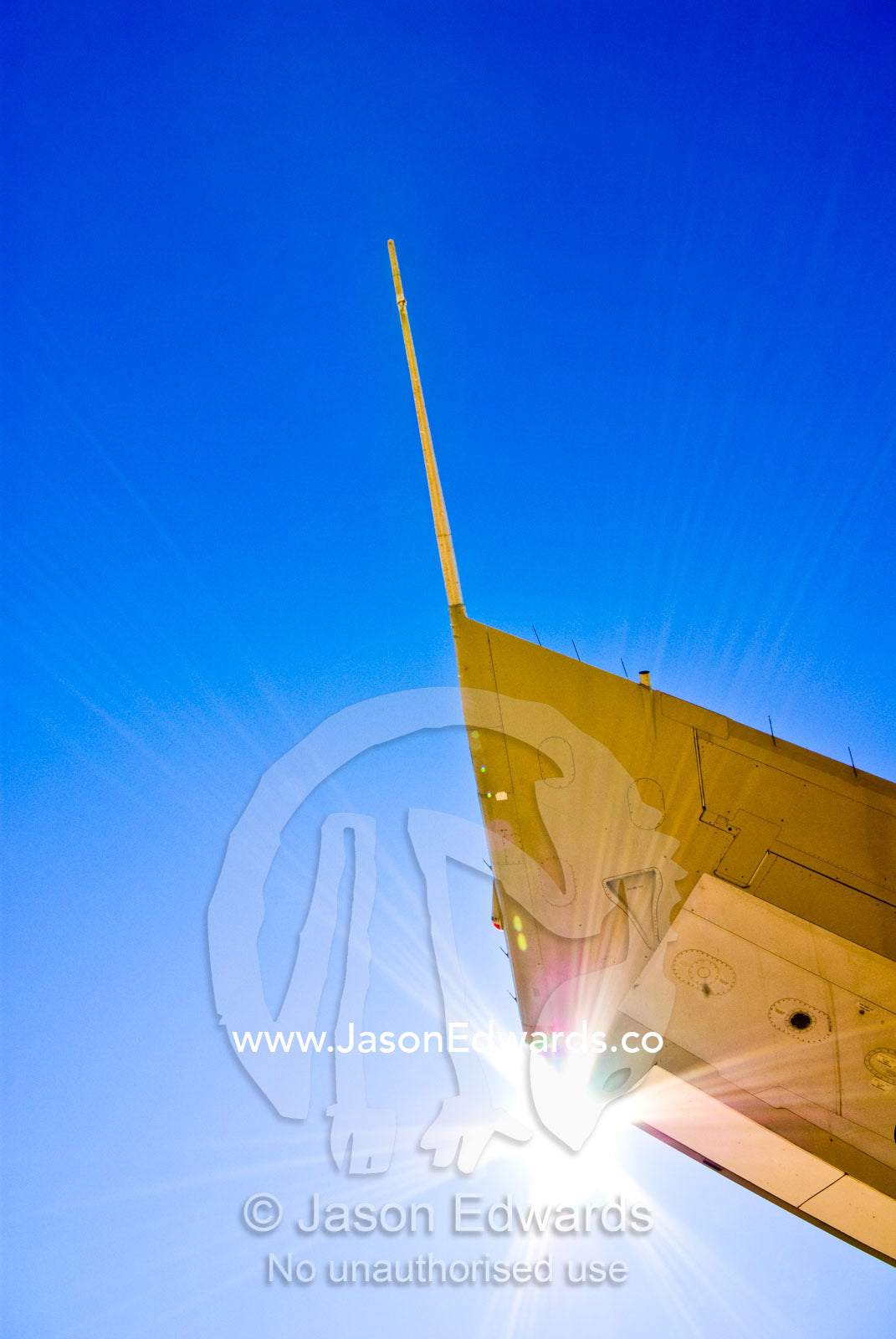 The wing tip of a 747 passenger aircraft soars into a clear blue sky. Longreach, Queensland, Australia