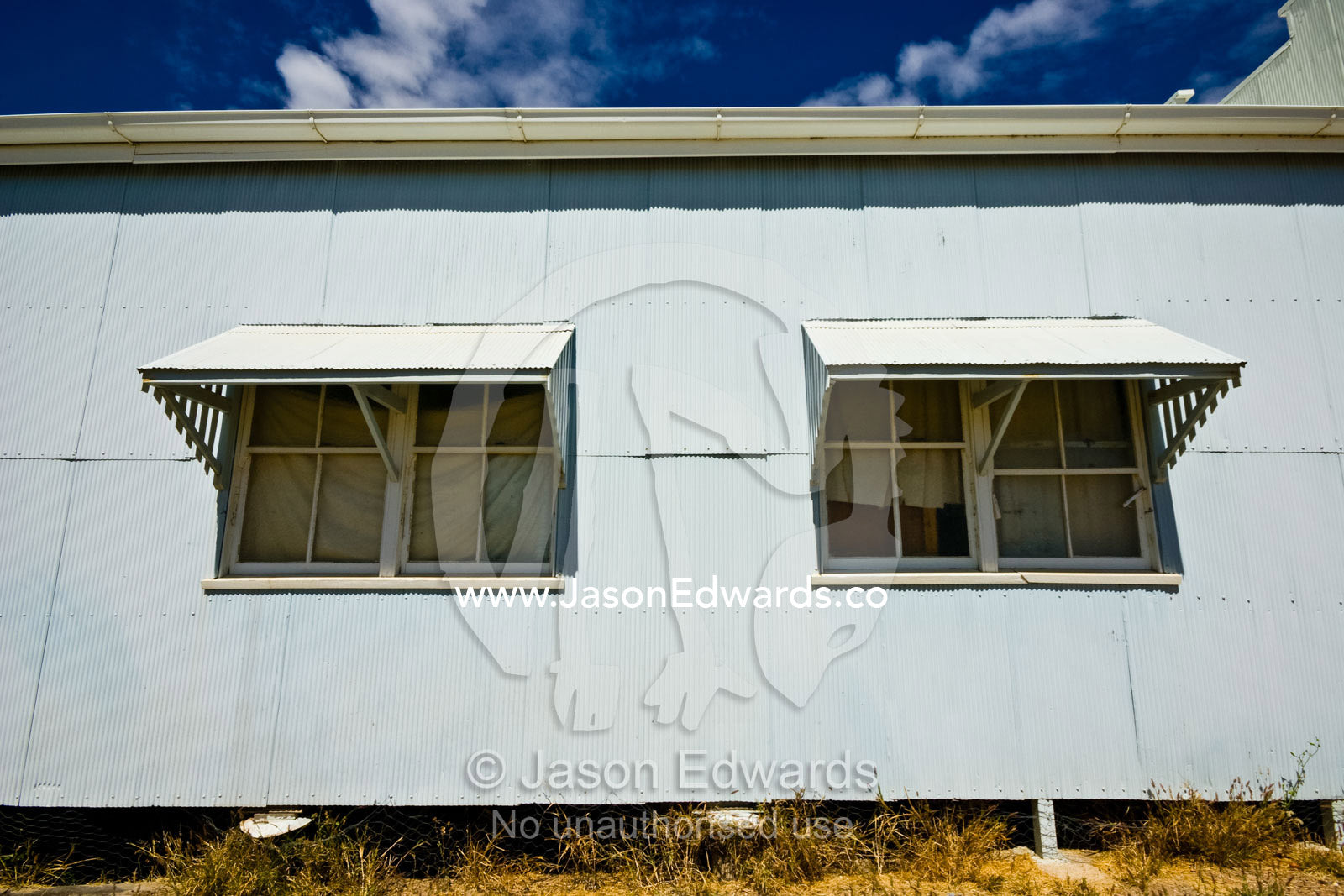 Large awnings cast deep shadows over windows in a baking outback town Hughenden, Queensland, Australia