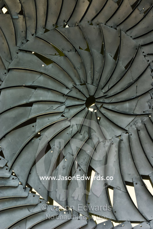 A steel plate public art sculpture depicts the spirals of an ammonite. Hughenden, Queensland, Australia
