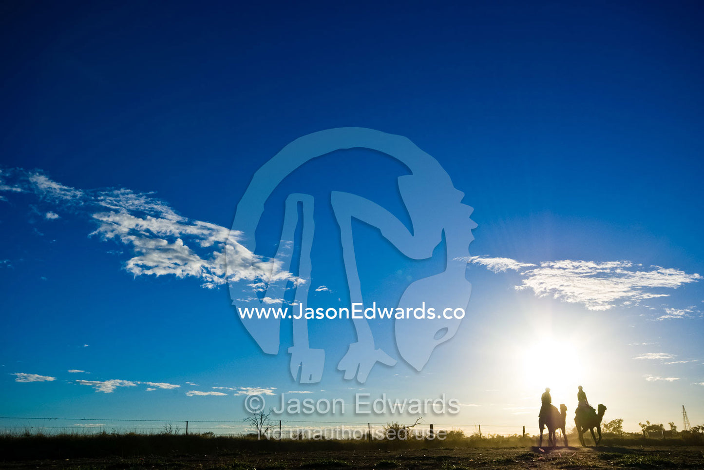 Camel jockeys plod on through the Outback during an endurance race. Hughenden, Queensland, Australia