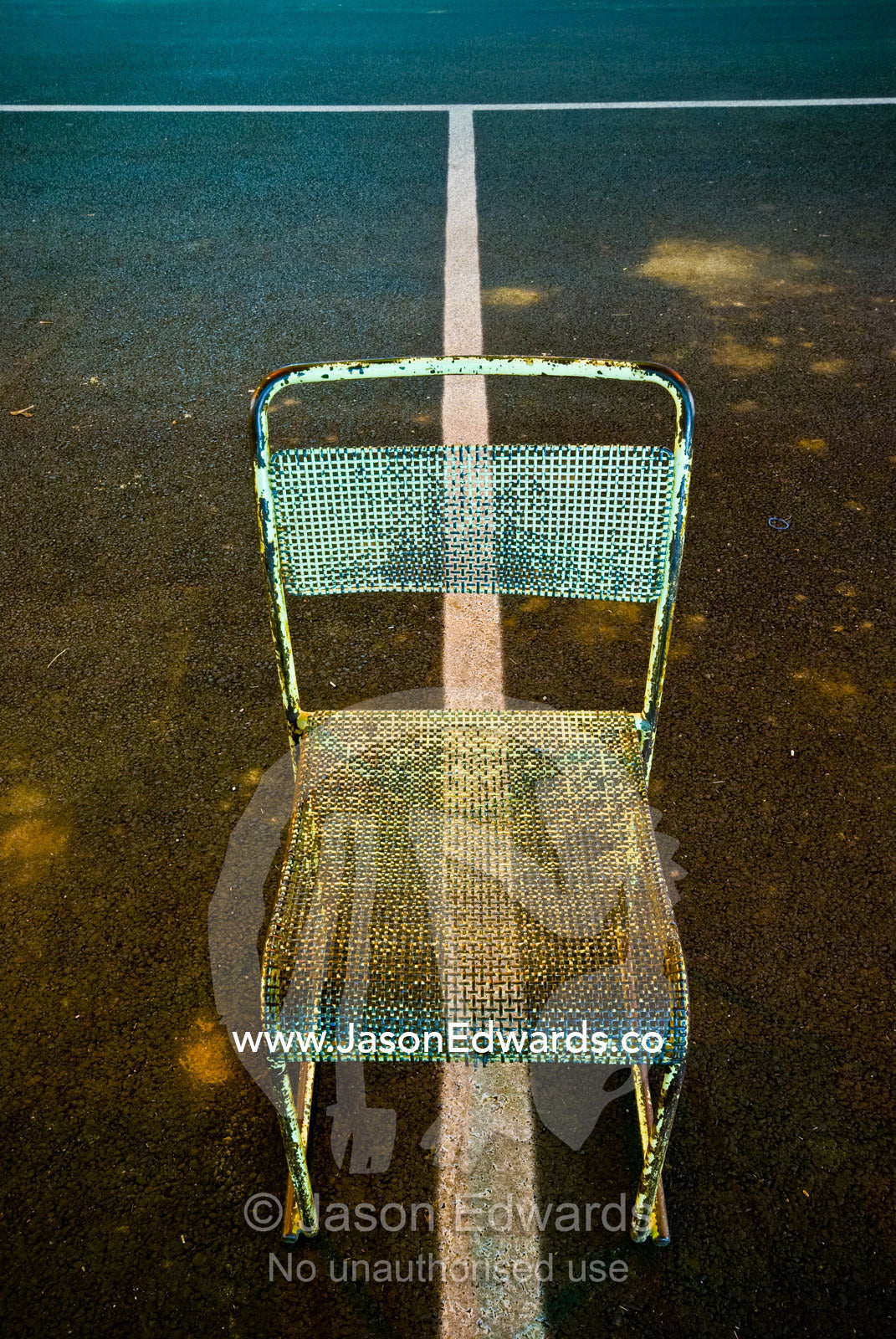 After a festival a steel chair lies abandoned in an empty car park. Hughenden, Queensland, Australia