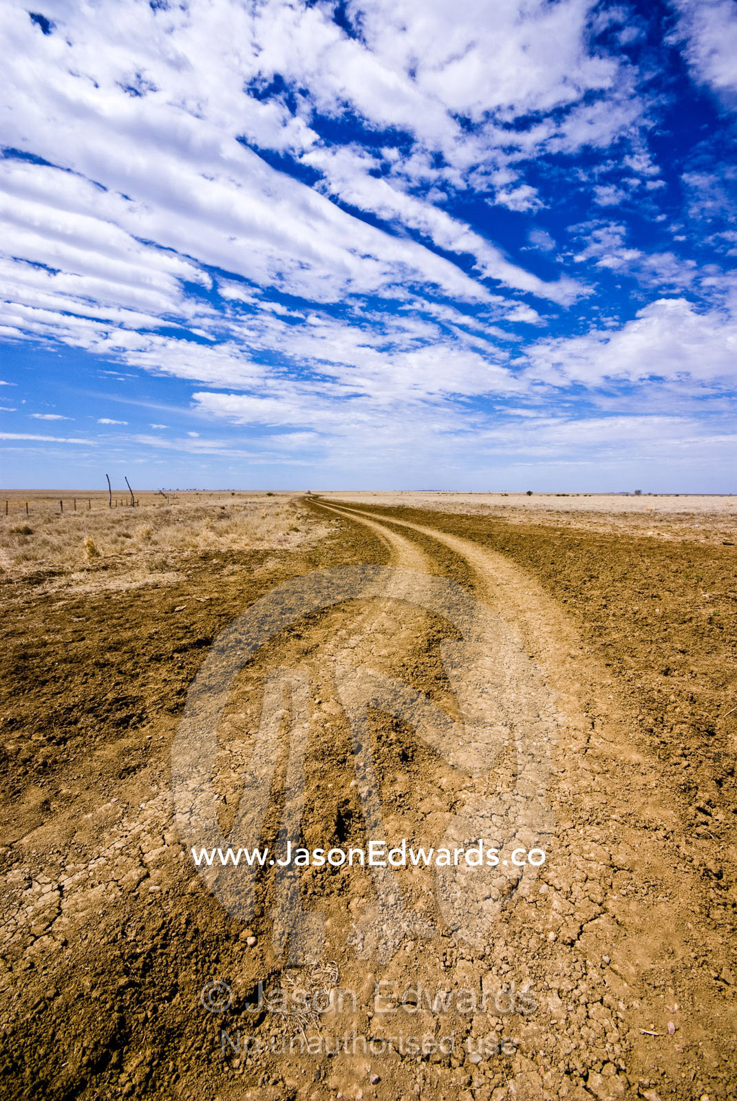 A winding dirt track constitutes a major arterial road in the Outback. Hughenden Muttaburra Road, Queensland, Australia