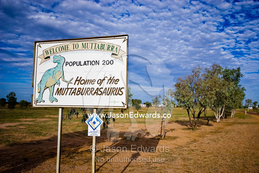 A welcome sign in a tiny Outback town displays a dinosaur discovery. Muttaburra, Queensland, Australia