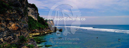 Rugged limestone cliffs overlook tranquil tropical bays and clean surf Uluwatu, Bukit Peninsula, Bali, Indonesia