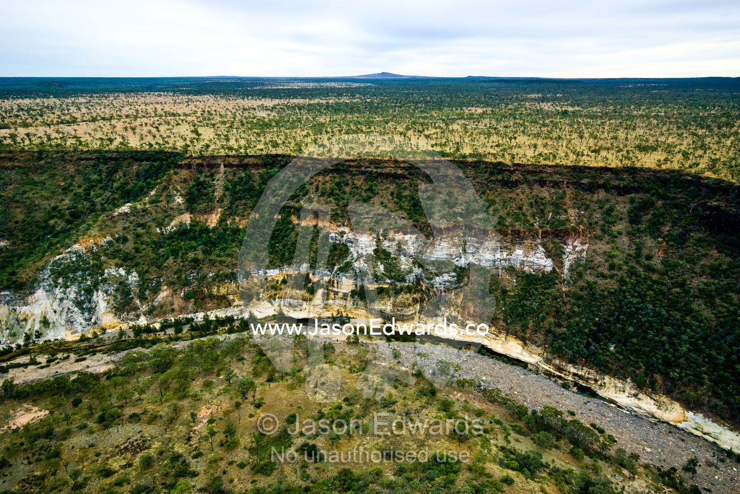 The sheer walls of a winding canyon cut through vast savannah plains. Porcupine Gorge National Park, Queensland, Australia.