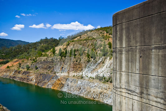 The concrete tower of a dam wall rises over dwindling water supplies. Eildon Weir Spillway, Lake Eildon, Victoria, Australia.