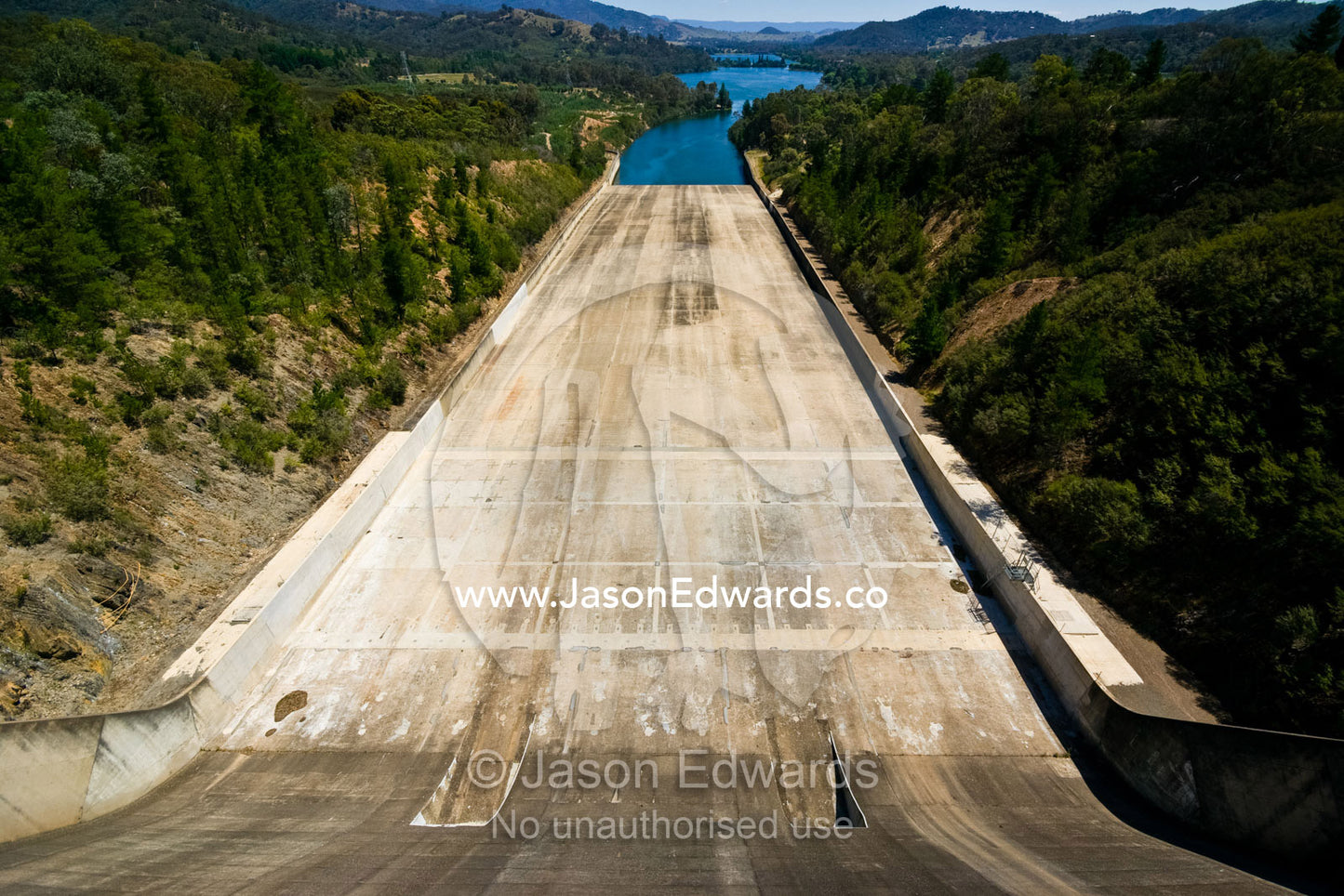 The massive concrete slide of a dam spillway and water reservoir. Eildon Weir Spillway, Lake Eildon, Victoria, Australia