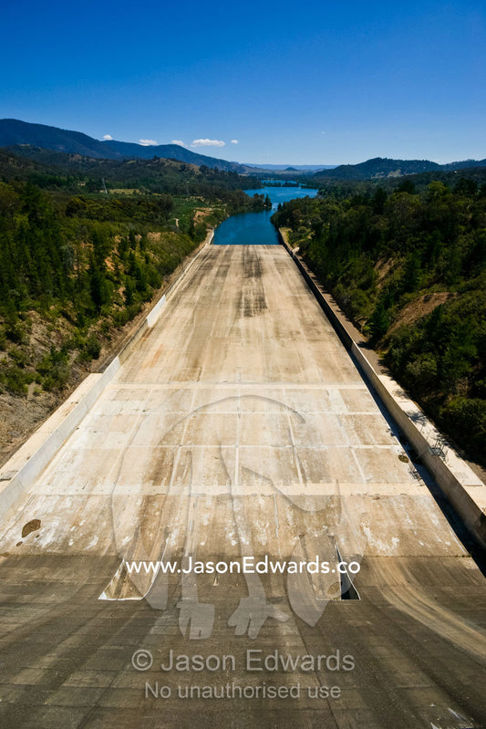 The massive concrete slide of a dam spillway and water reservoir. Eildon Weir Spillway, Lake Eildon, Victoria, Australia