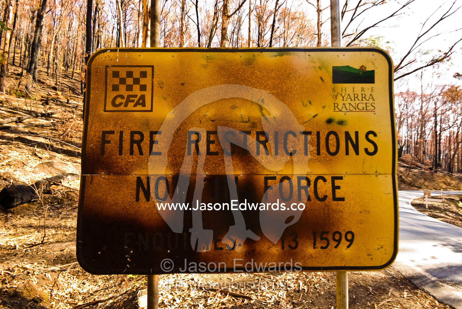 An official fire restriction sign in a national park destroyed by fire Near Toolangi, Yarra Ranges National Park, Victoria, Australia