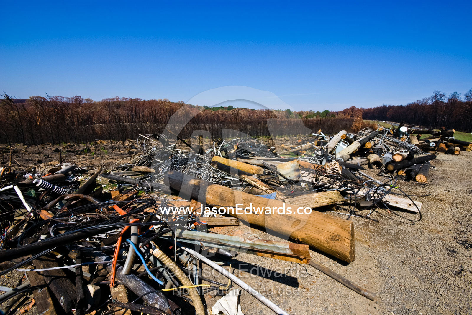 Discarded telephone and electricity supply cables destroyed by a fire. near Hazeldene, Victoria, Australia