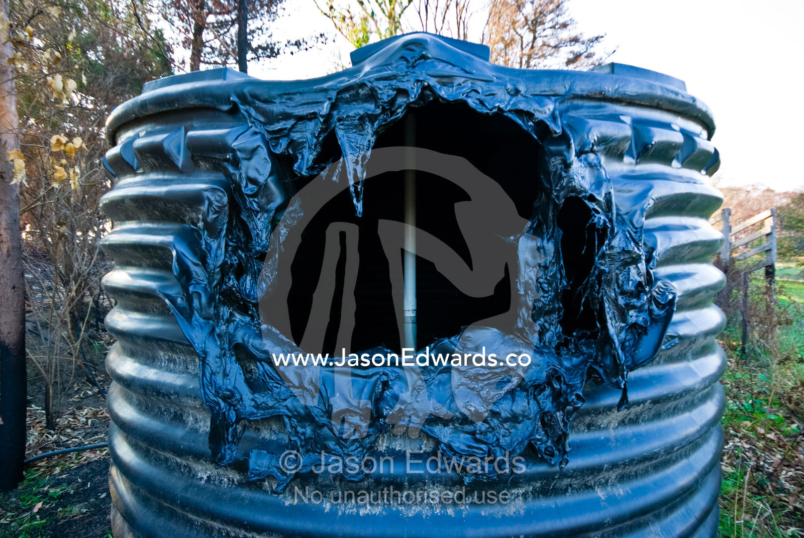 A plastic water tank melted in the extreme heat of a forest fire. Kinglake Central, Victoria, Australia