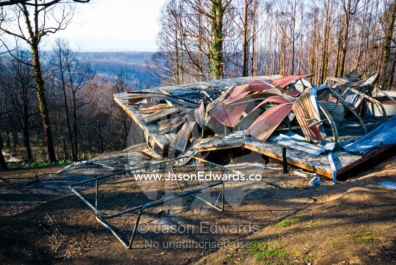 A family home destroyed by fire collapses in on the car garage below. Kinglake, Victoria, Australia