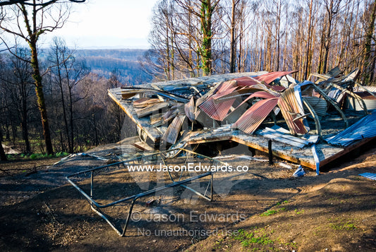 A family home destroyed by fire collapses in on the car garage below. Kinglake, Victoria, Australia