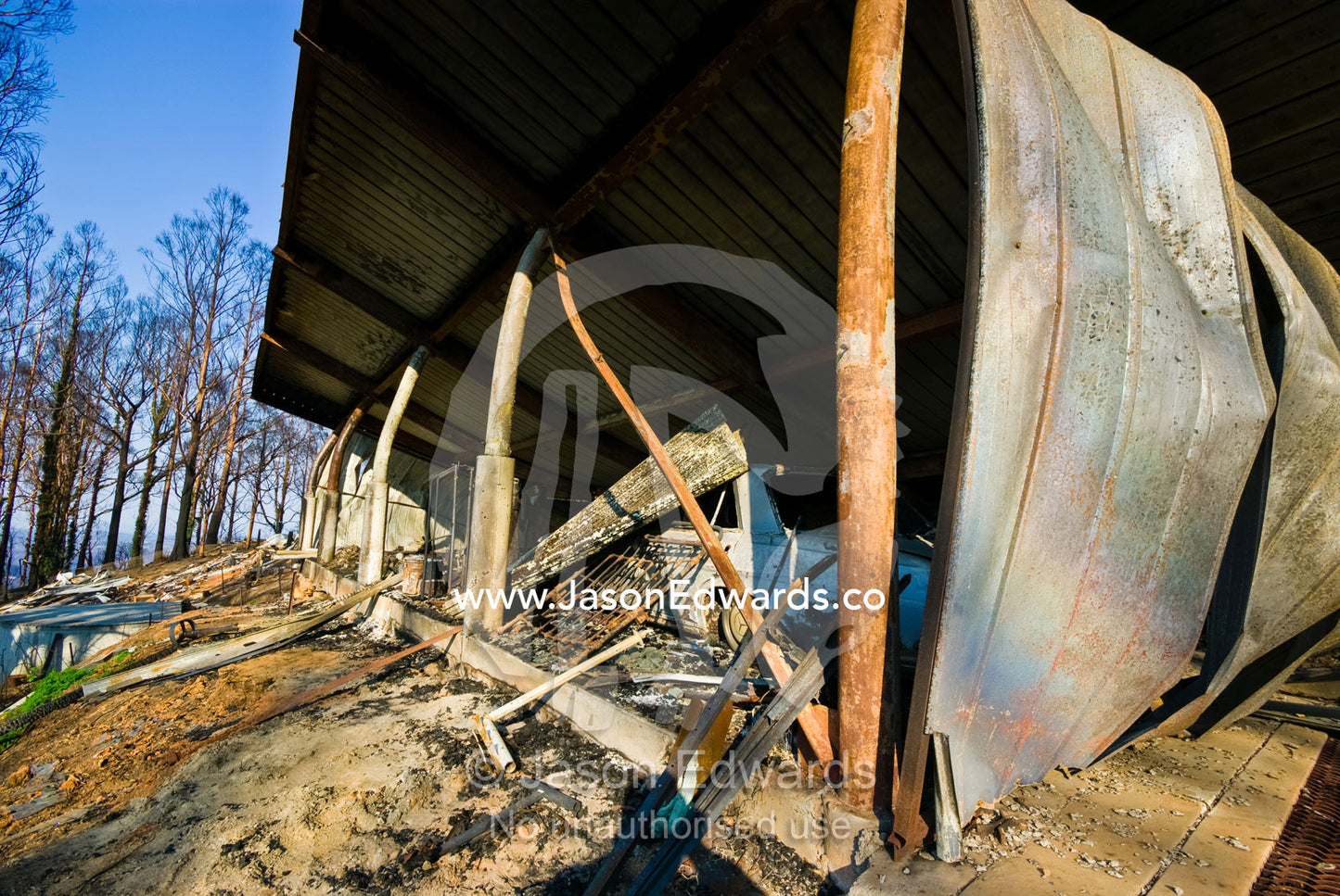 A family home destroyed by fire collapses in on the car garage below. Kinglake, Victoria, Australia