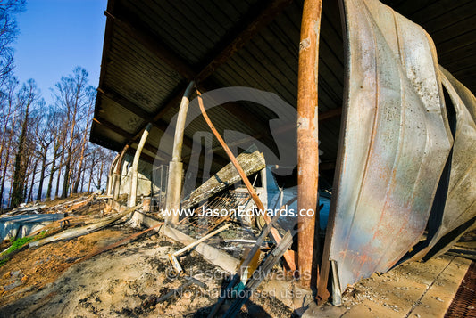 A family home destroyed by fire collapses in on the car garage below. Kinglake, Victoria, Australia