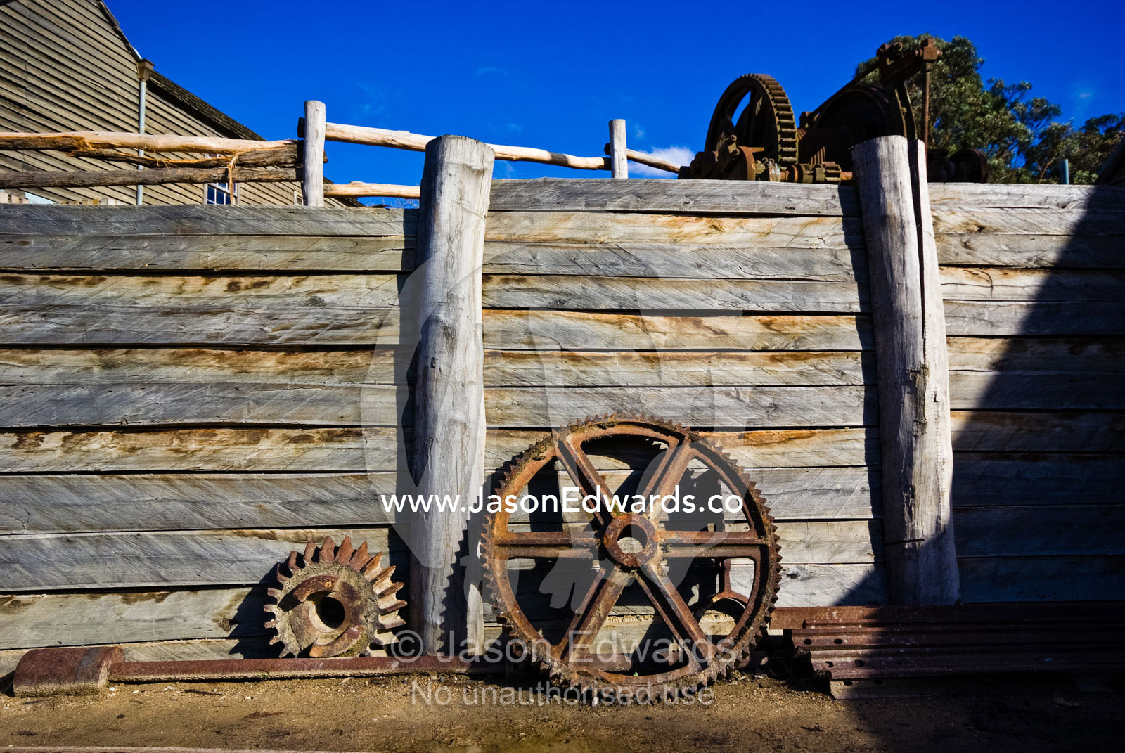 Steam engine steel pulley wheels against a gold mine retaining wall. Ballarat, Victoria, Australia.