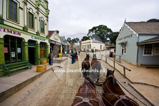 A team of Clydesdale horses pull a stagecoach in a gold mining town. Ballarat, Victoria, Australia.