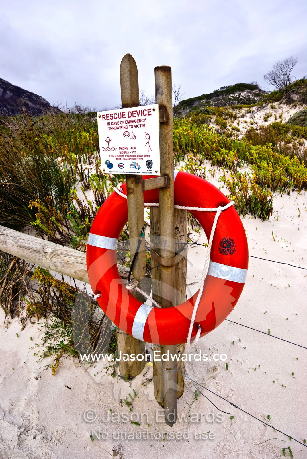 A bright red rescue ring used for emergencies at a dangerous beach. Squeaky Beach, Wilsons Promontory National Park, Victoria, Australia