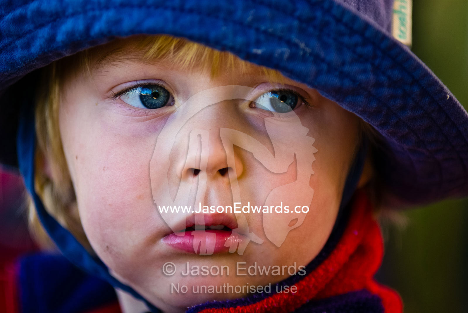 A small boy with a sad expression after an altercation over a toy. Werribee Open Range Zoo, Werribee, Victoria, Australia