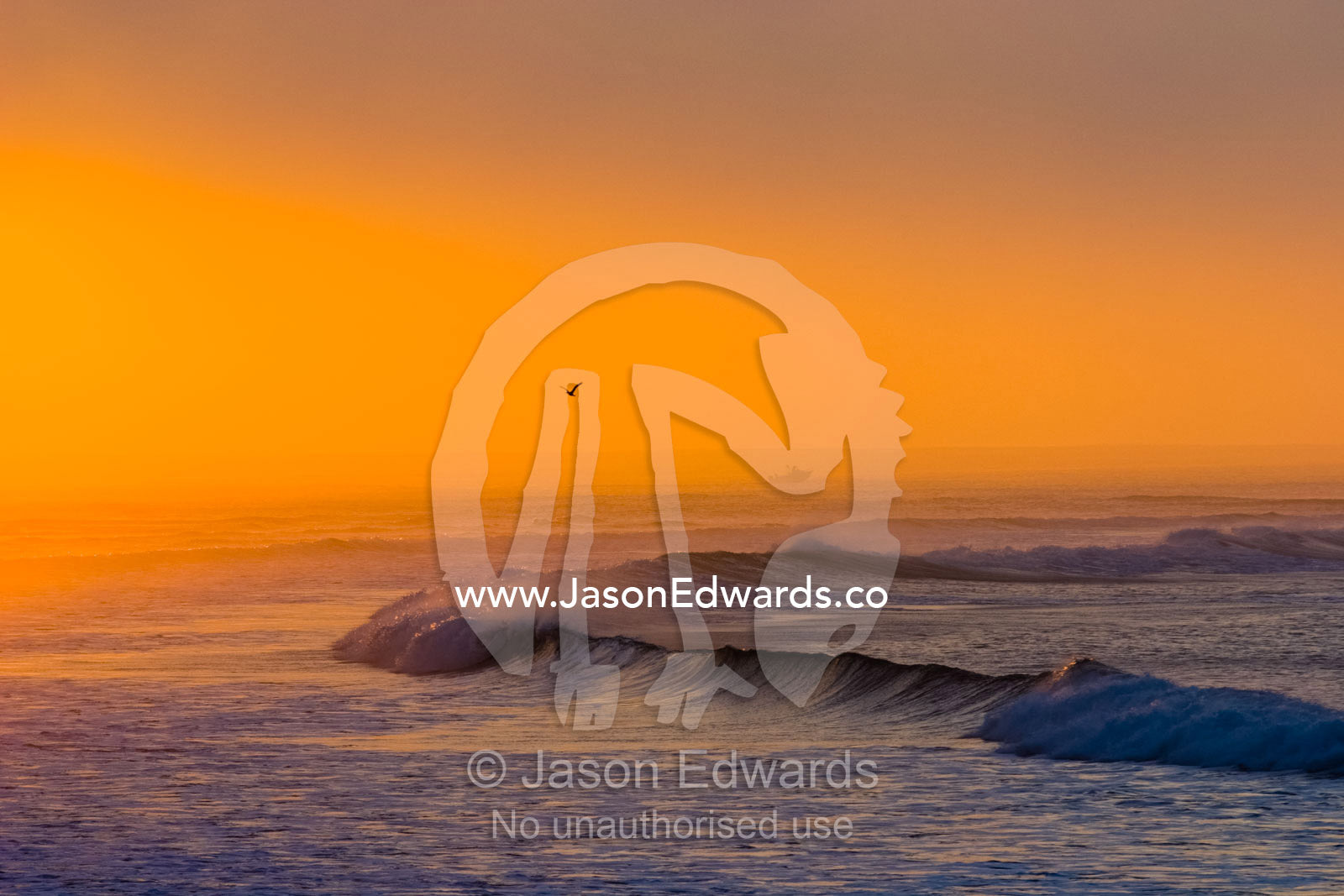A pastel dawn rises over misty ocean surf swell on a warm Autumn day. Point Danger, Torquay, Surf Coast, Victoria, Australia