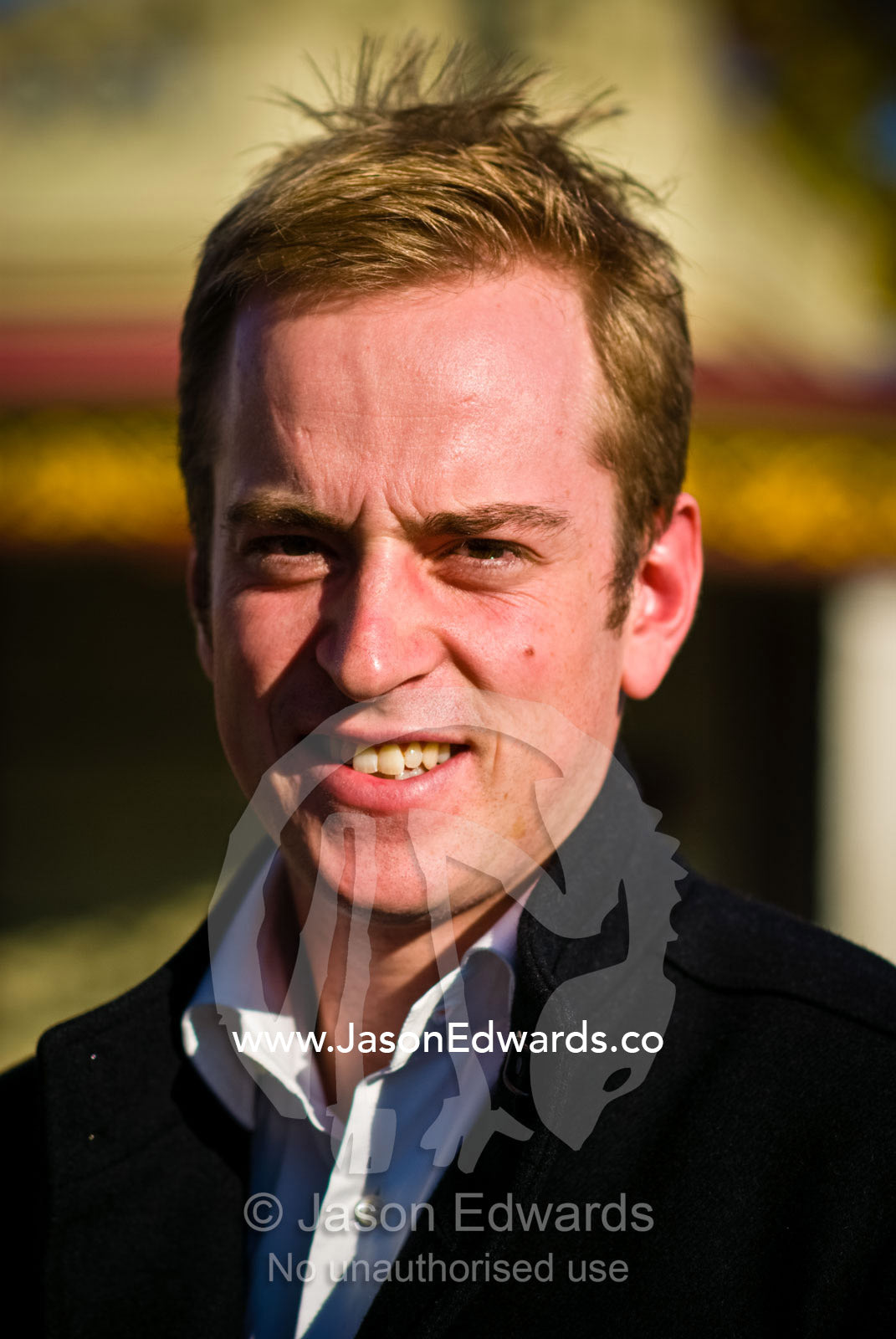 A young fair-skinned man in a black jacket smiles at the camera North Carlton, Victoria, Australia