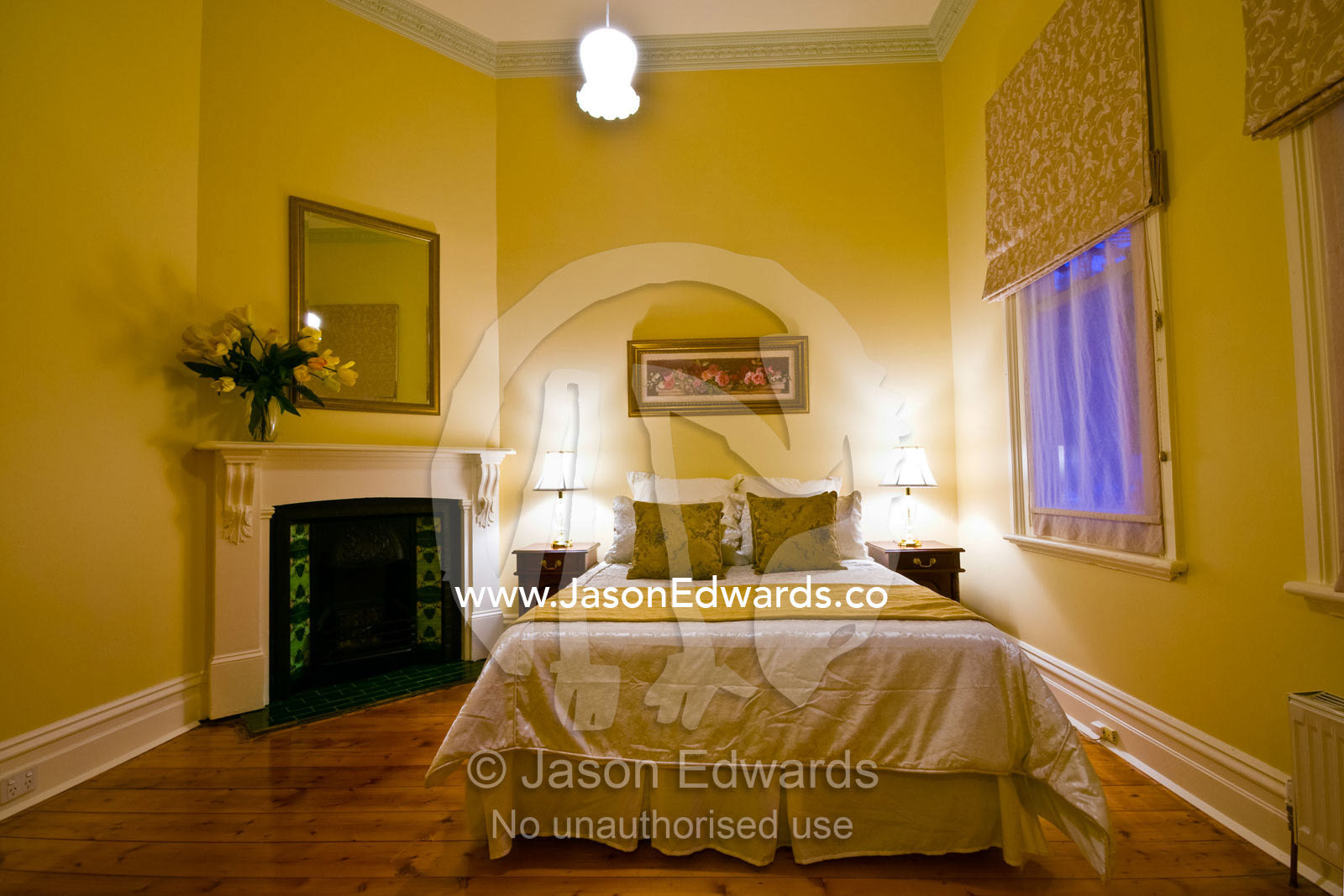 An elegant master bedroom with fireplace in a Heritage home. Brunswick, Victoria, Australia