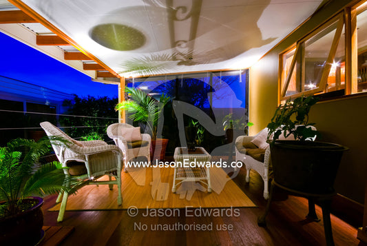 An outdoor patio and entertainment area overlooks a garden at night. Northcote, Victoria, Australia