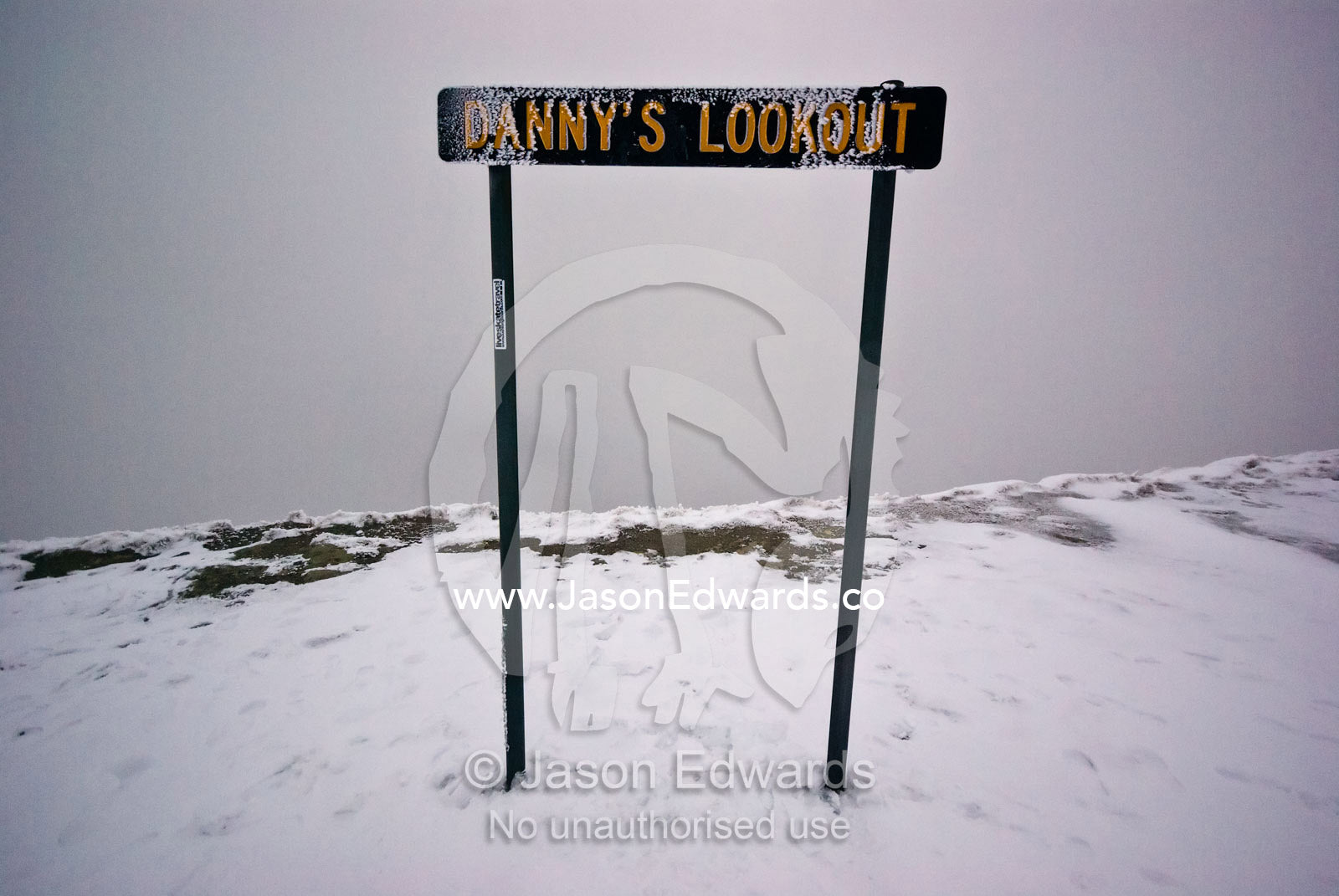 An ice encrusted sign indicates a scenic lookout lost in a storm. Danny's Lookout, Mount Hotham, Great Dividing Range, Victoria, Australia