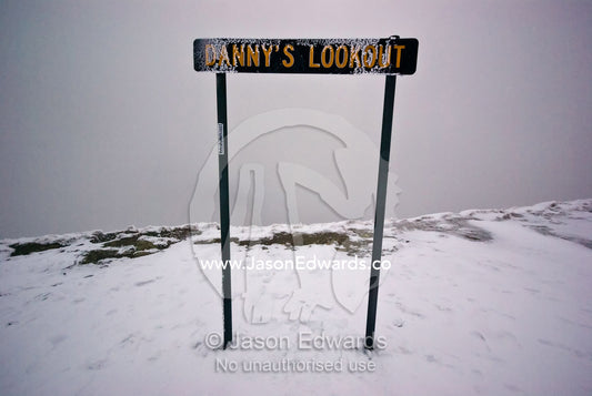 An ice encrusted sign indicates a scenic lookout lost in a storm. Danny's Lookout, Mount Hotham, Great Dividing Range, Victoria, Australia
