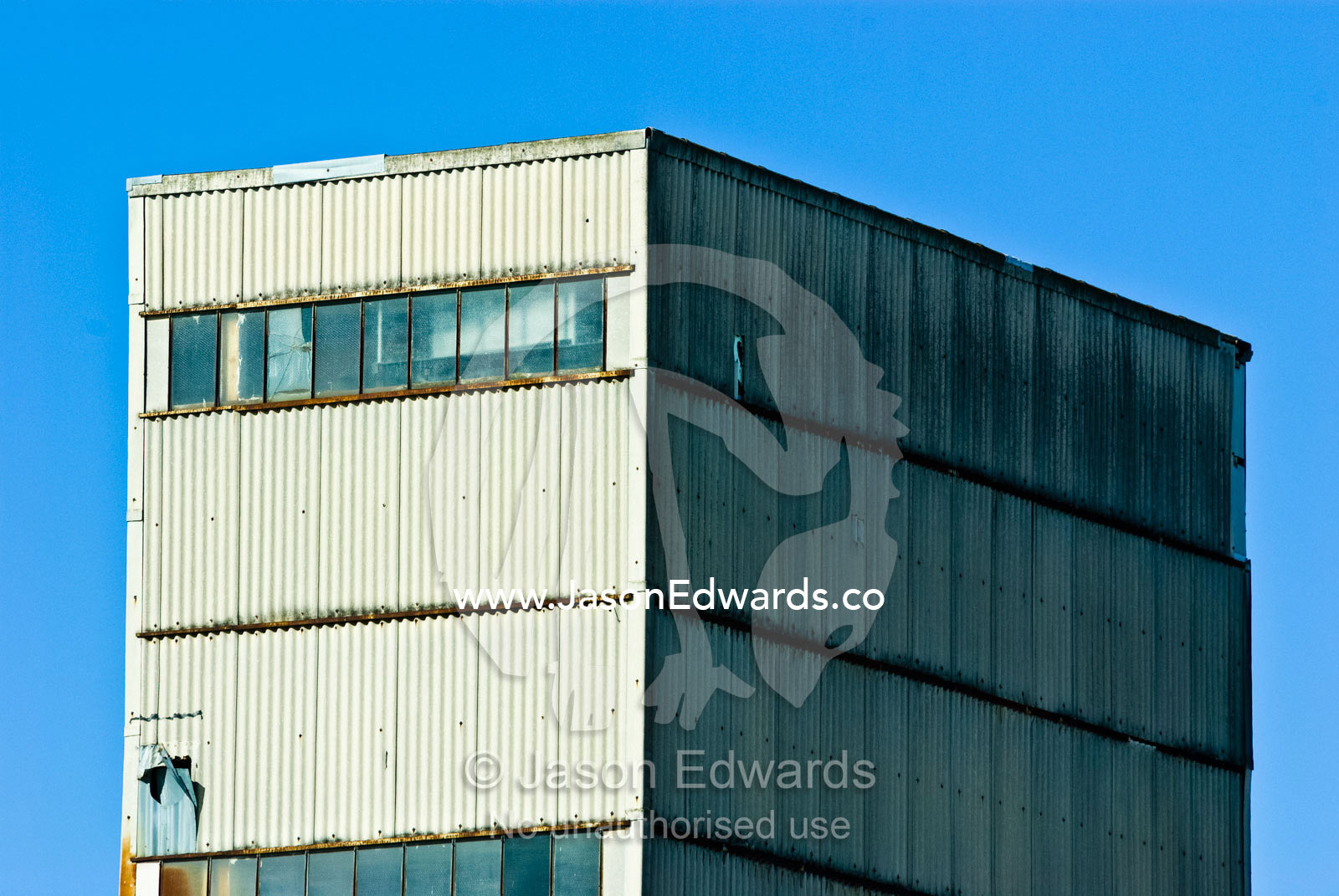 A rectangular rusting corrugated tin factory warehouse facade. Collingwood, Victoria, Australia