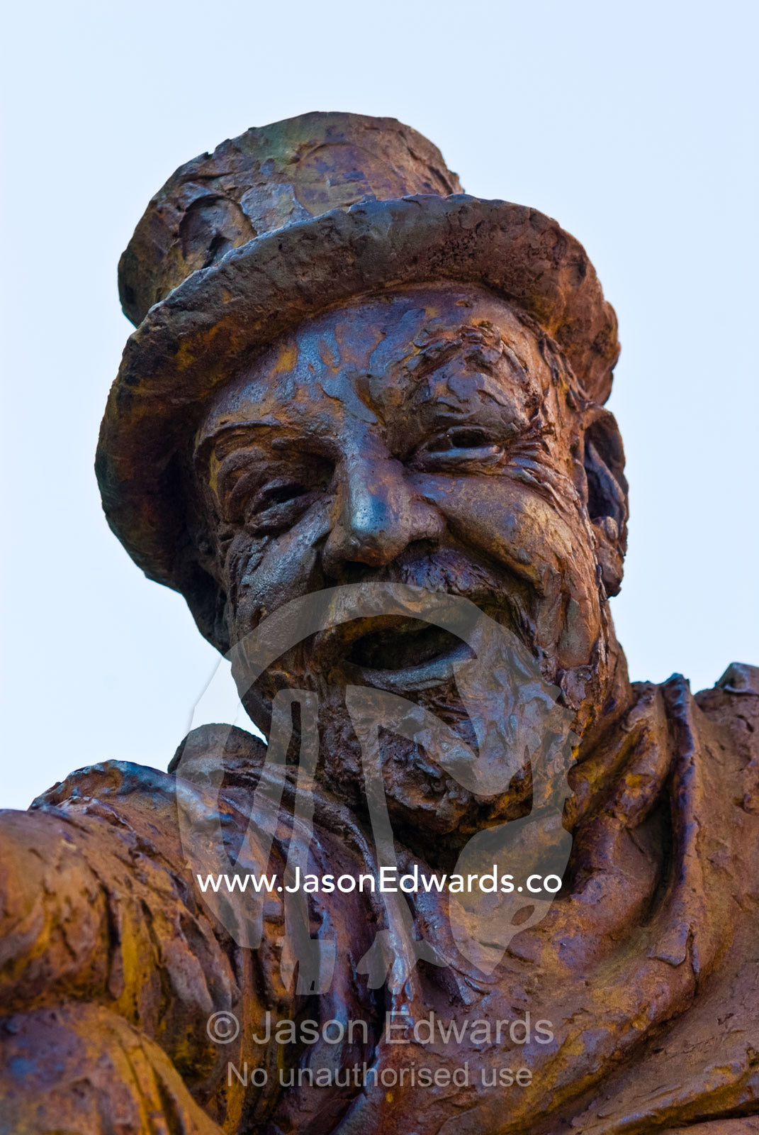 A bronze statue of a bearded man wearing a top hat. Brunswick Street, Fitzroy, Victoria, Australia