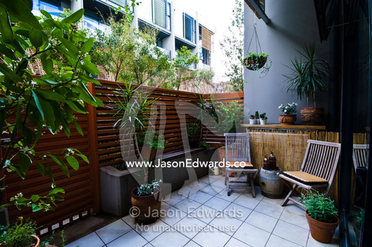 A small paved and gardened courtyard in an inner city townhouse. North Melbourne, Victoria, Australia
