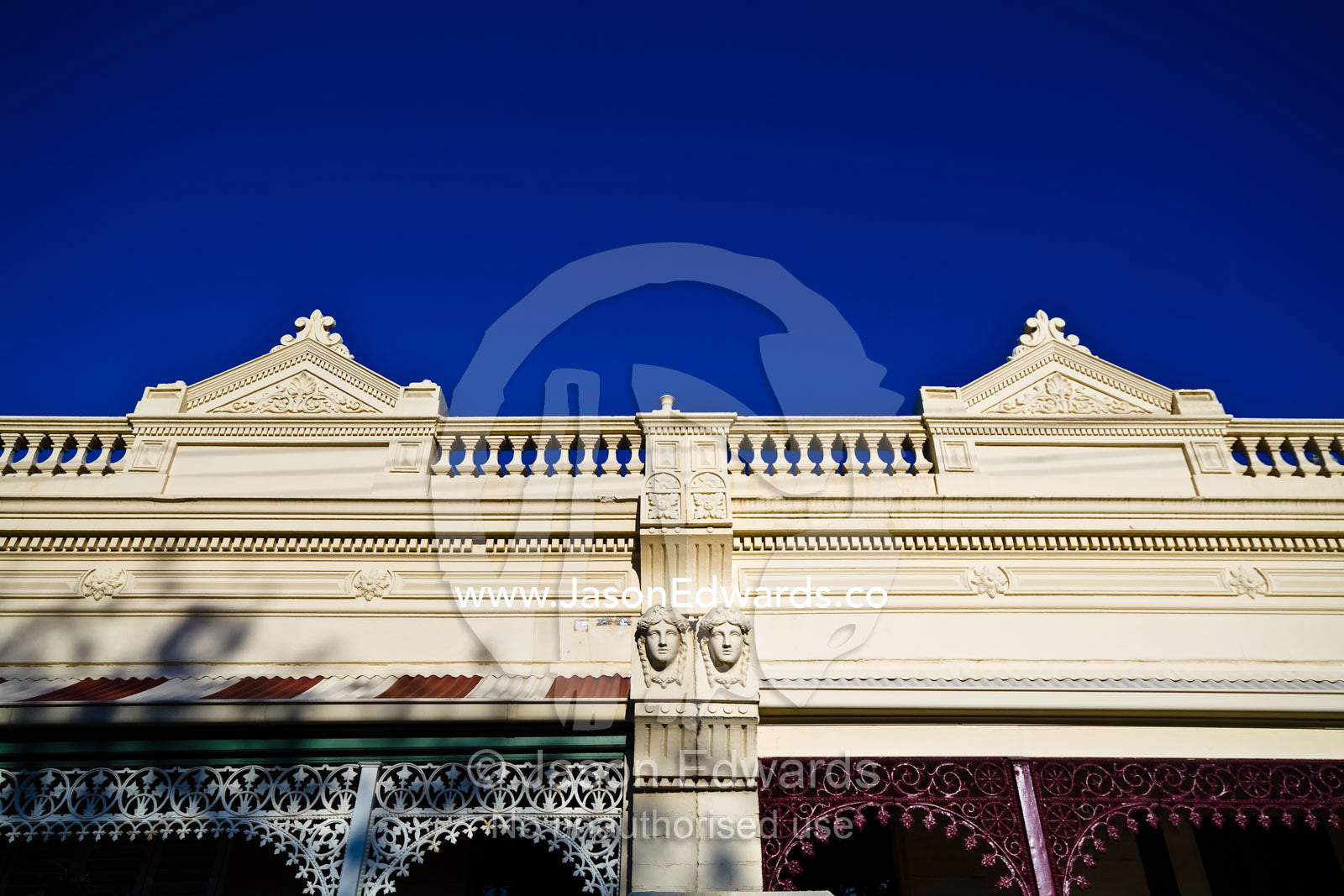 Ornate steel lattice verandahs and English Victorian terrace facades. Carlton North, Victoria, Australia