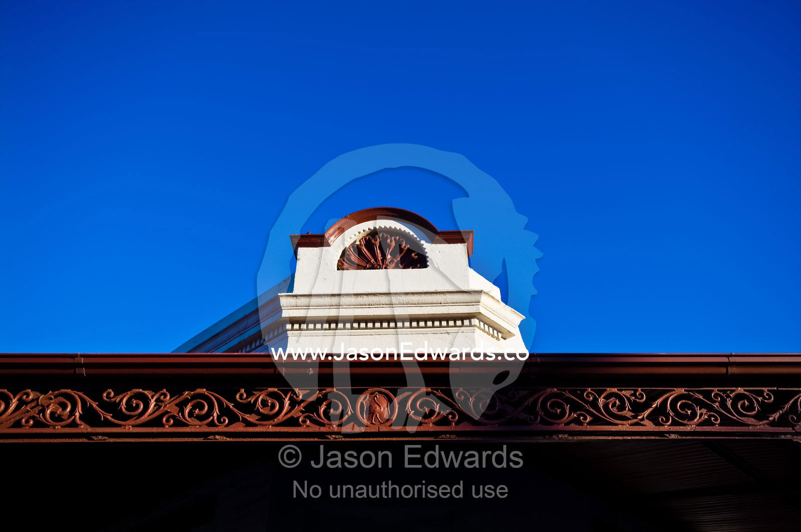 An ornate facade and verandah lattice on an antique terrace house. Carlton North, Victoria, Australia