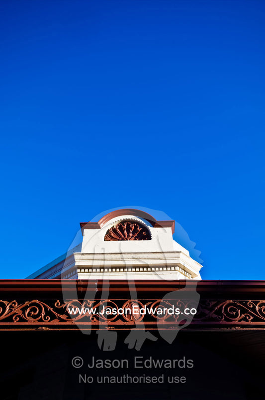 An ornate facade and verandah lattice on an antique terrace house. Carlton North, Victoria, Australia