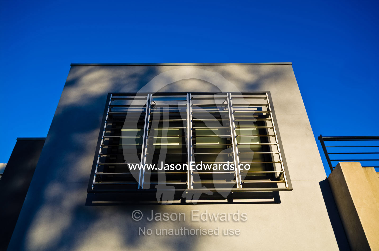 Aluminum shutters protect a window in a modern home. Carlton North, Victoria, Australia