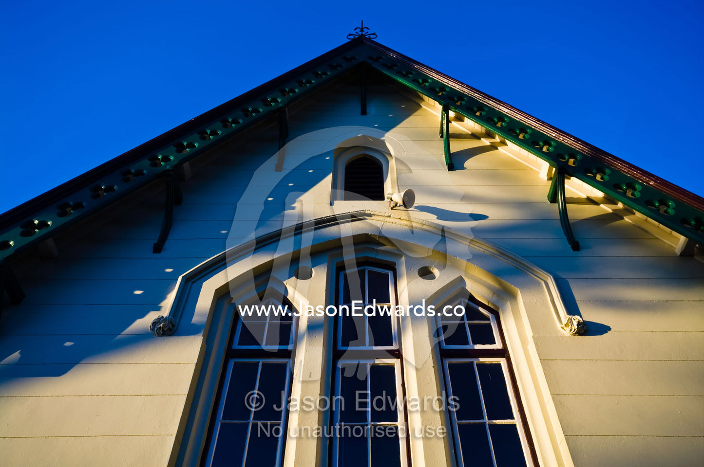 The ornate facade and window panes of a Victorian elementary school. Carlton North, Victoria, Australia