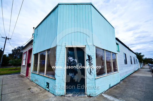Graffiti on an old corner store painted blue and turned into a house. Fitzroy North, Victoria, Australia