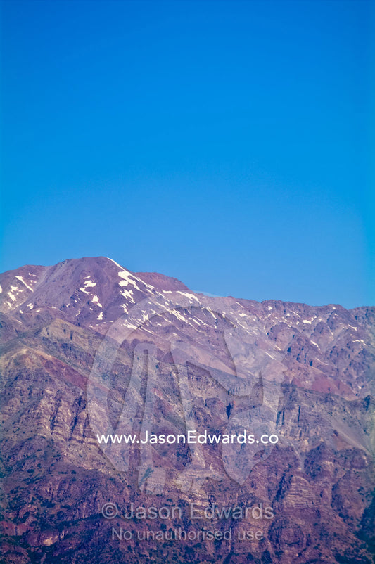The last of the winter snows cling to rugged bare mountain peaks. Maipo Valley, Andes Mountain Range, Santiago, Chile