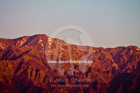The last of the winter snows cling to rugged mountain peaks at sunset. Maipo Valley, Andes Mountain Range, Santiago, Chile