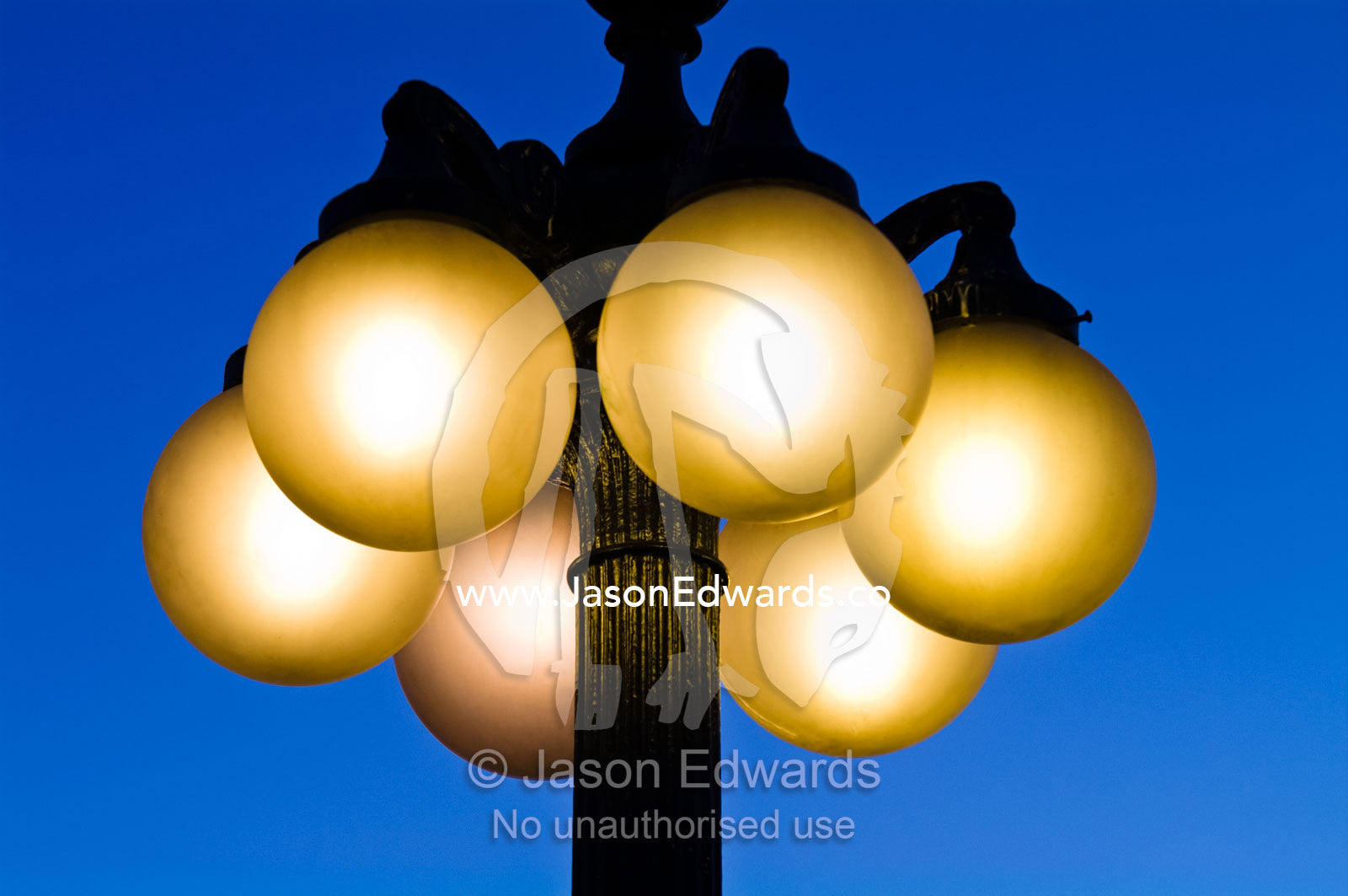 Antique spherical lights attached to ornate steel poles at sunset. Plaza Italia, Providencia District, Santiago, Chile