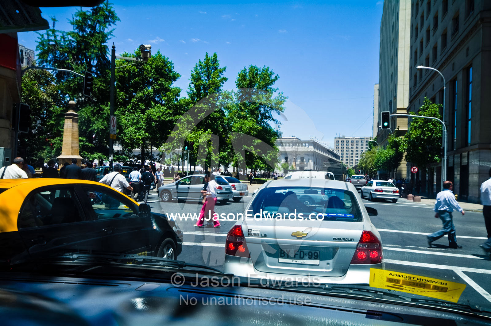 Traffic waits at an intersection for pedestrians to cross safely. Civic District, Santiago, Chile