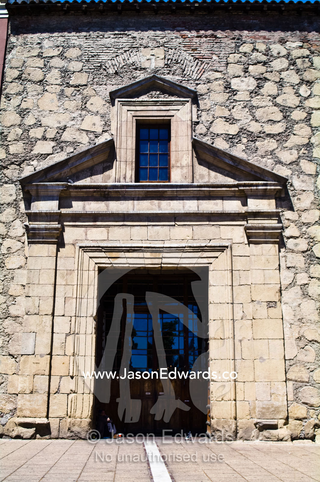 The stone wall and brick entrance to an ancient Christian church. Iglesia San Francisco, Santiago, Chile
