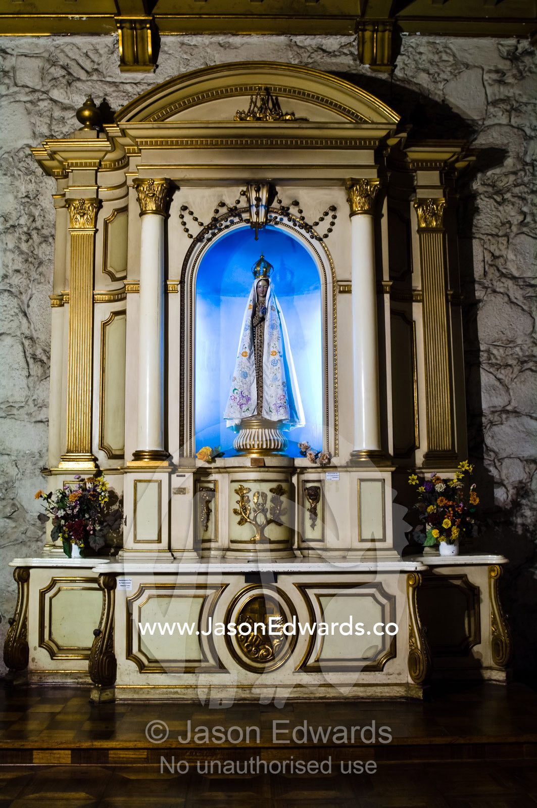 A statue of the Virgin Mary in an ancient stone Christian church. Iglesia San Francisco, Santiago, Chile
