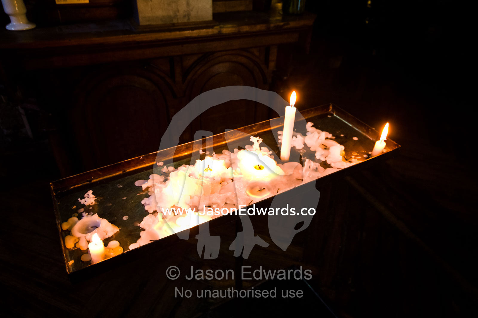 Melted wax and prayer candles in the central nave of a Catholic church Iglesia San Francisco, Santiago, Chile