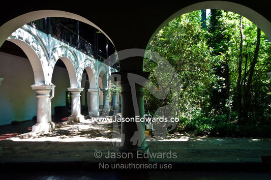 Arches lead from the covered patio of a monastery to a tranquil garden Iglesia San Francisco, Santiago, Chile