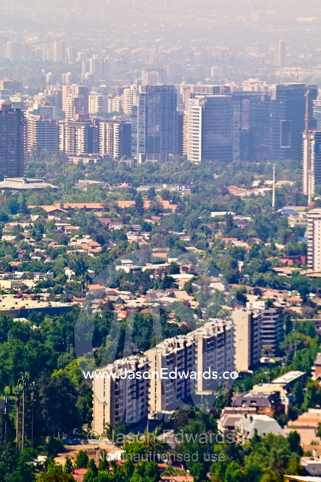 Summer smog and pollution in Santiago's suburbs and business district. Residencial Las Condes from Santa Maria de Manquehue, Santiago, Chile