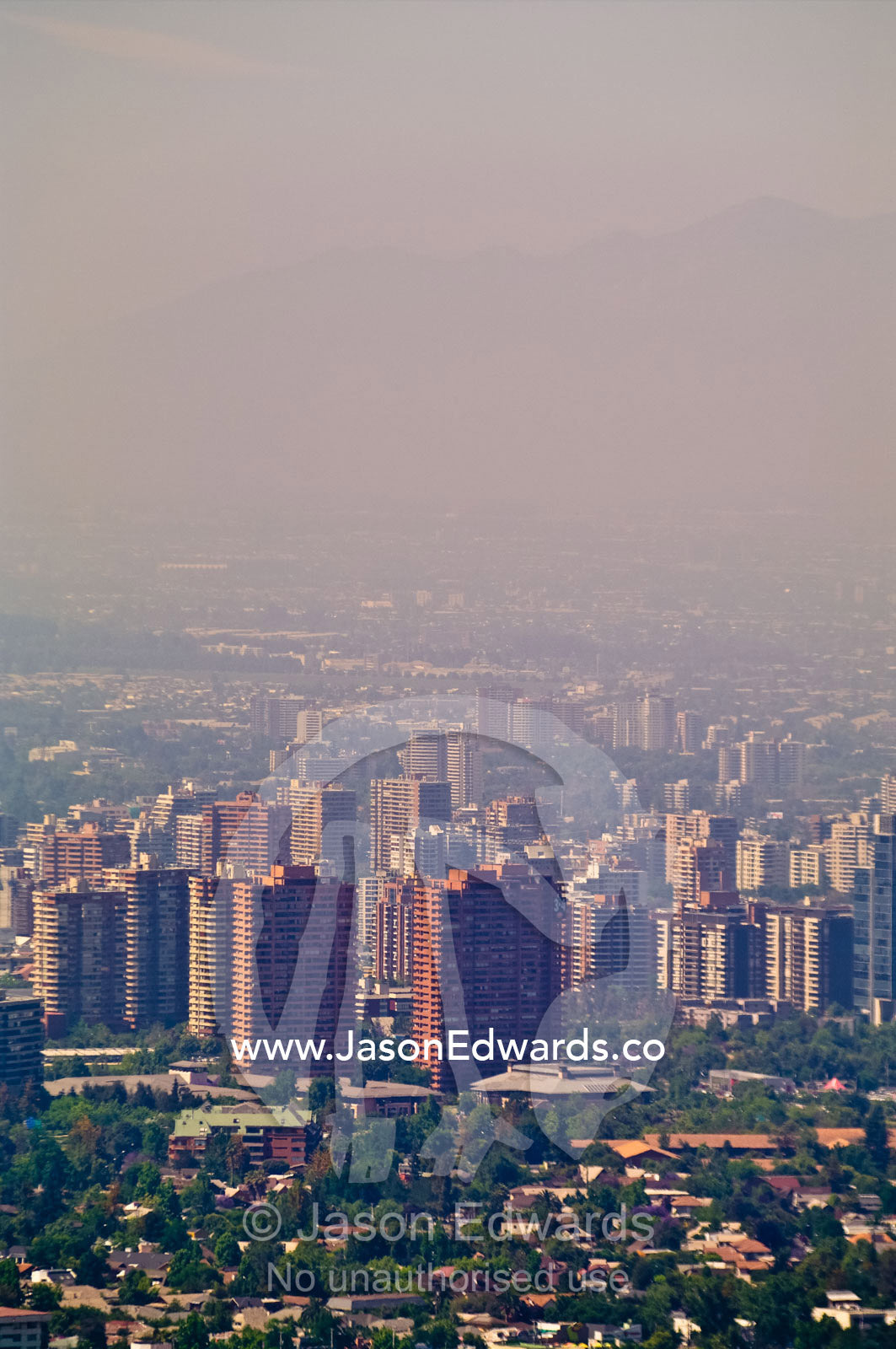 Summer smog and pollution in Santiago's suburbs and business district. Residencial Las Condes from Santa Maria de Manquehue, Santiago, Chile