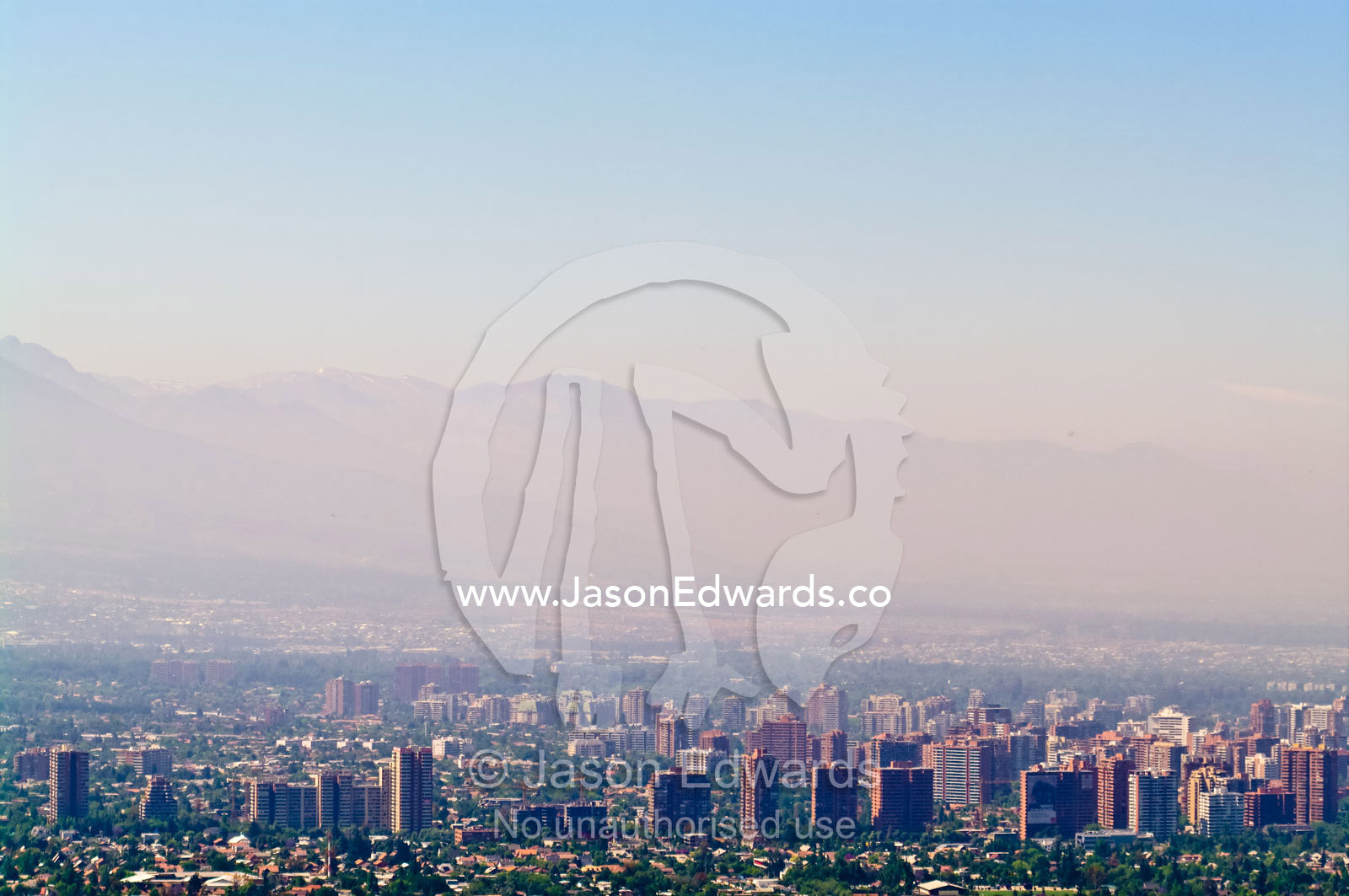 Summer smog and pollution in Santiago's suburbs and business district. Maipo Valley, Andes Mountain Range and Residencial Las Condes from Santa Maria de Manquehue, Santiago, Chile