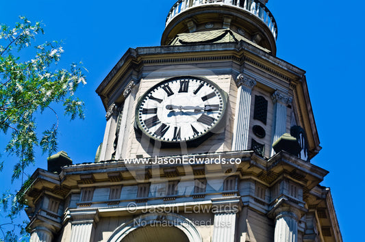 A clock face rests atop an ancient Christian church steeple. Iglesia San Francisco, Santiago, Chile